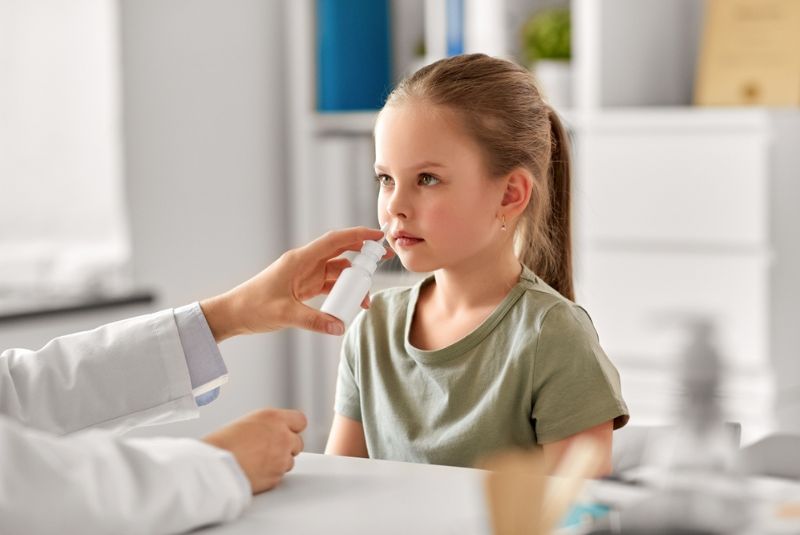 Child being given nasal spray