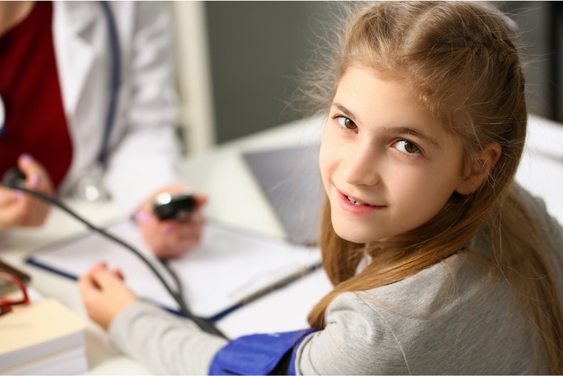 A child has a blood pressure check