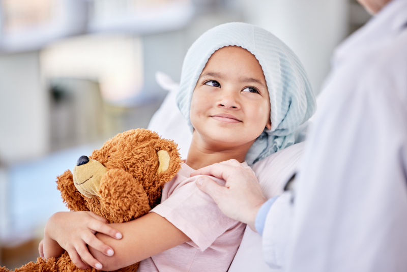 Childhood cancer patient holding stuffed animal