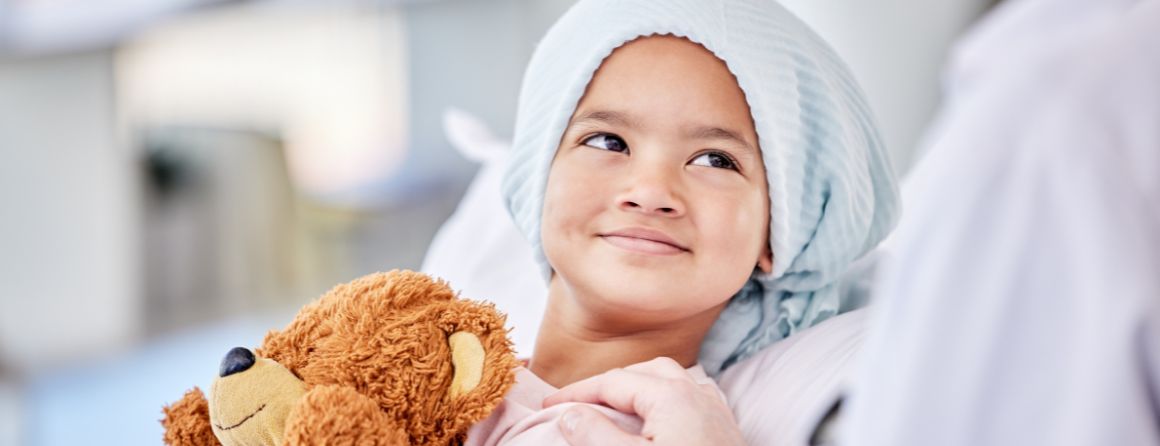 Childhood cancer patient holding stuffed animal