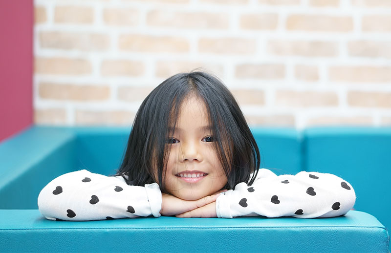 Smiling child on a blue couch